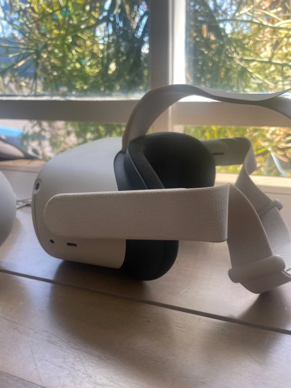 Oculus white standalone VR headset with white controllers and black face gasket